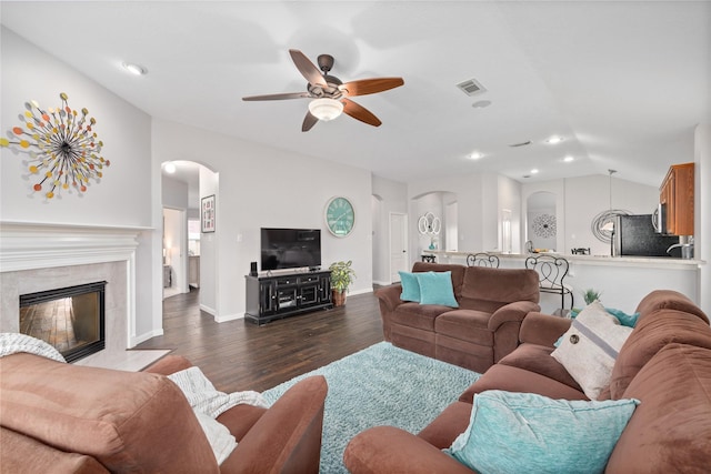 living room with ceiling fan, lofted ceiling, dark hardwood / wood-style flooring, and a premium fireplace