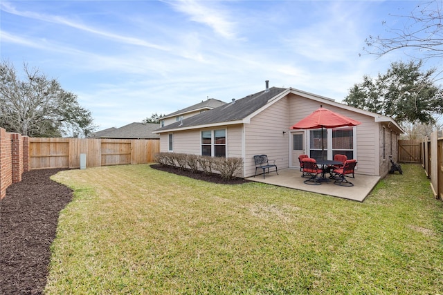 back of property with a yard and a patio area