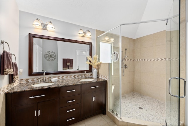 bathroom with vanity, lofted ceiling, an enclosed shower, and tile patterned floors