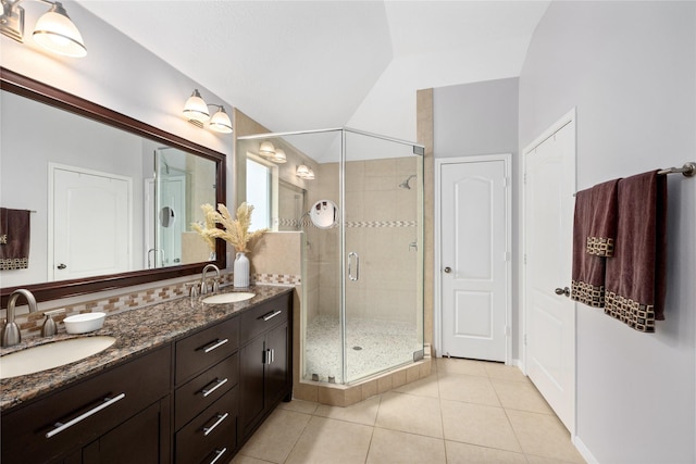 bathroom featuring lofted ceiling, tile patterned floors, a shower with shower door, and vanity