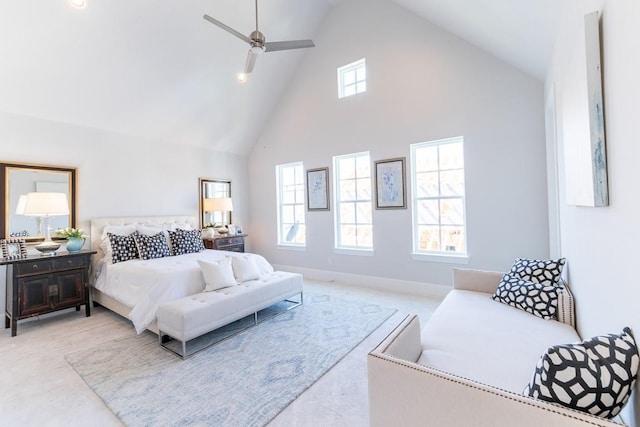 bedroom with ceiling fan, light colored carpet, high vaulted ceiling, and multiple windows