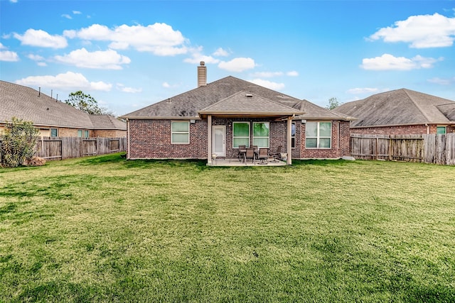 back of property featuring a patio area and a lawn