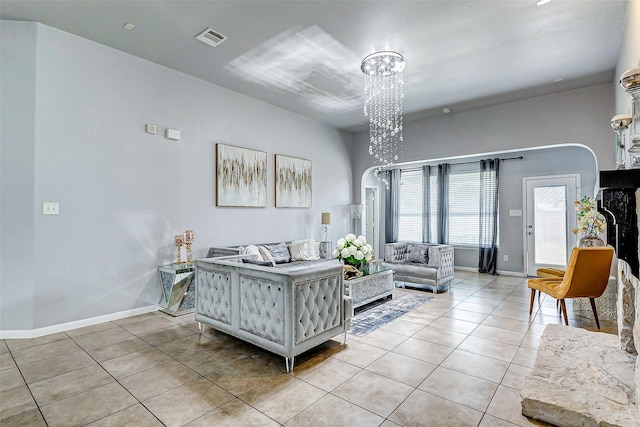 tiled living room featuring a chandelier