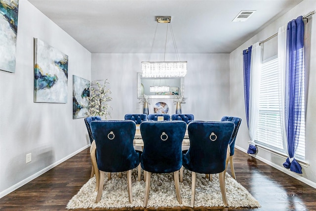 dining space featuring a notable chandelier and dark wood-type flooring