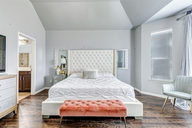 bedroom with vaulted ceiling, ensuite bathroom, and dark hardwood / wood-style flooring