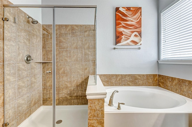 bathroom featuring separate shower and tub