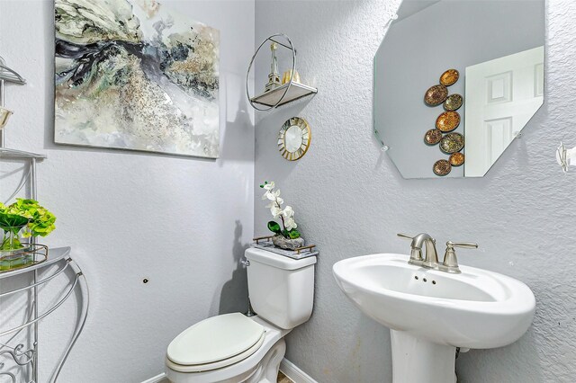 bathroom with toilet and sink