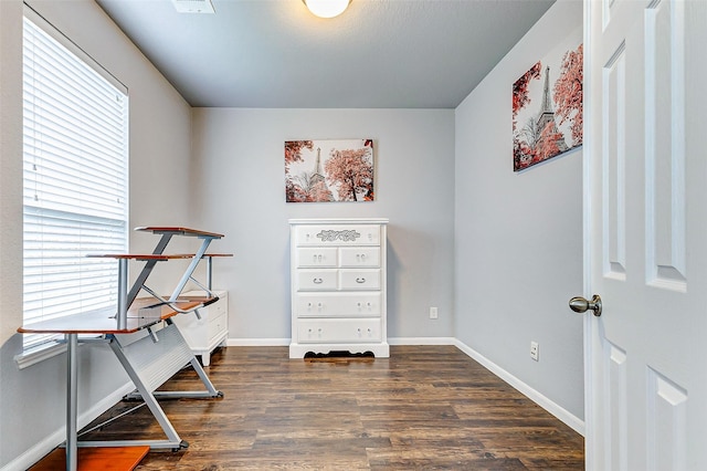 office area with a wealth of natural light and dark hardwood / wood-style flooring