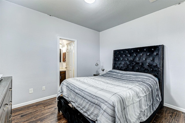 bedroom with dark hardwood / wood-style floors and ensuite bathroom