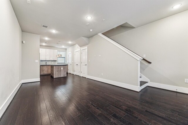 unfurnished living room with dark hardwood / wood-style flooring