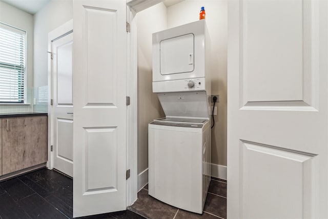 laundry area with stacked washer and clothes dryer