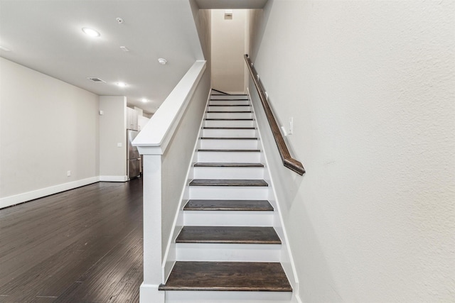 staircase with hardwood / wood-style flooring