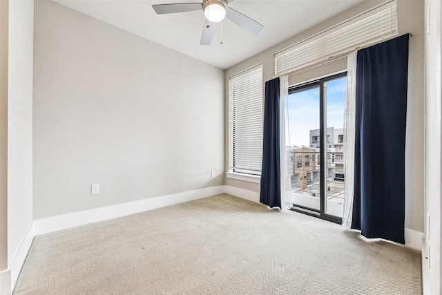 carpeted empty room featuring ceiling fan