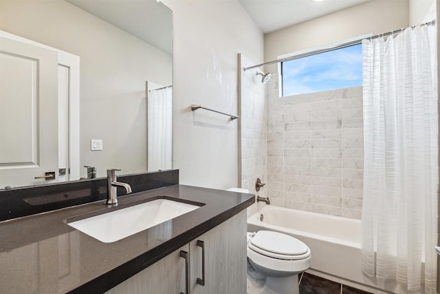 full bathroom with shower / tub combo, vanity, tile patterned floors, and toilet