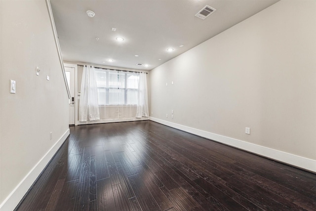 spare room featuring dark wood-type flooring