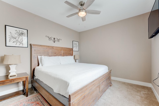 bedroom with ceiling fan and light carpet