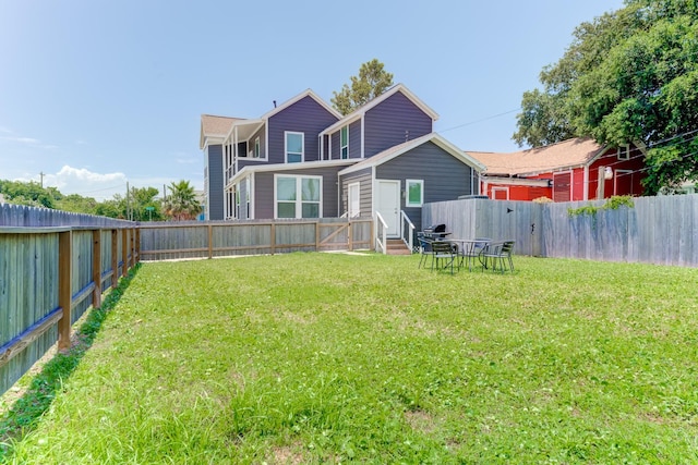 rear view of house with a yard