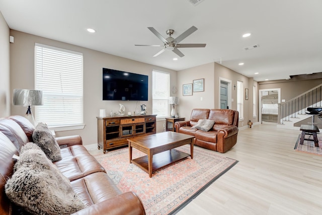 living room with ceiling fan and light hardwood / wood-style floors