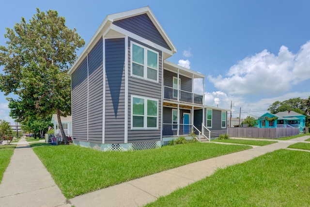 view of front of home with a front lawn and a balcony