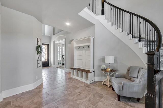 stairway featuring a high ceiling