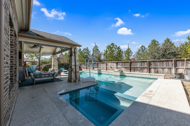 view of swimming pool featuring ceiling fan and a patio