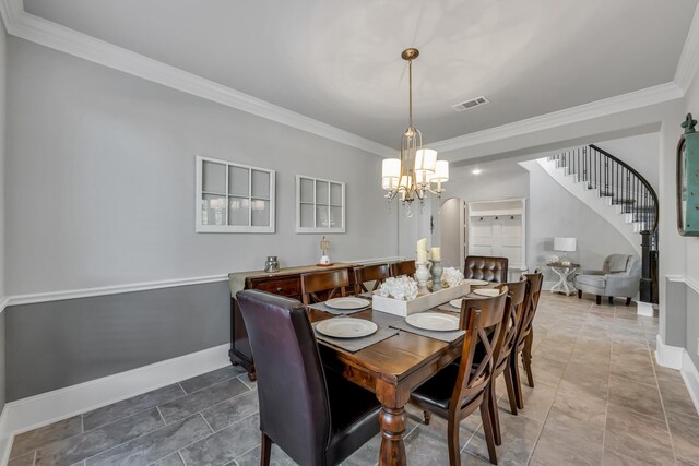 tiled dining room featuring ornamental molding and a notable chandelier