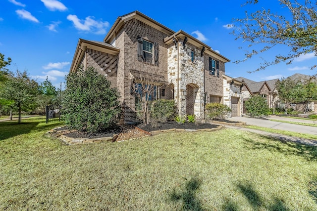 view of front of home with a garage and a front lawn