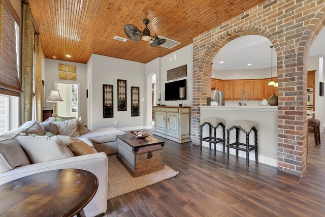 living room featuring dark hardwood / wood-style flooring, sink, wood ceiling, and ceiling fan