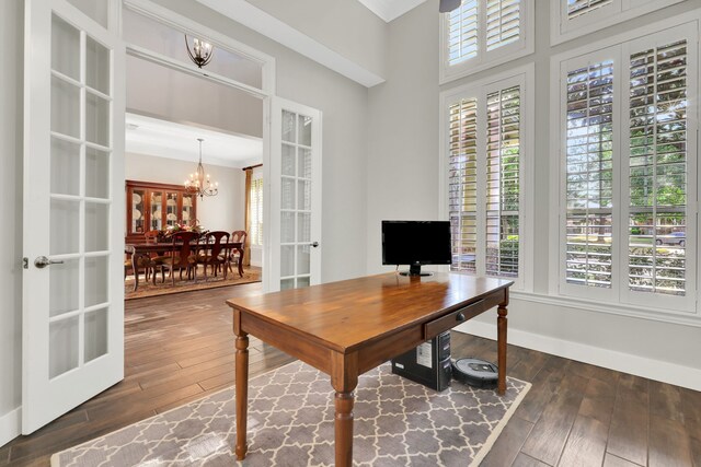 home office featuring dark hardwood / wood-style flooring, a chandelier, and french doors