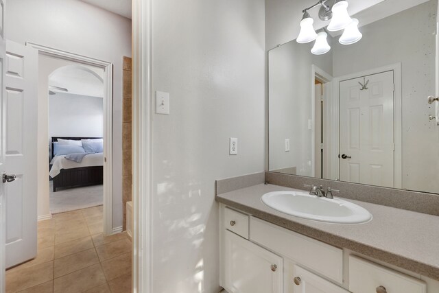 bathroom featuring tile patterned flooring, vanity, and a washtub