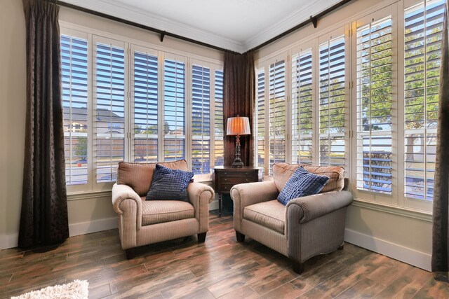 living area featuring ornamental molding and dark hardwood / wood-style flooring