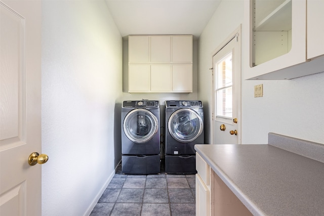 laundry area featuring washing machine and dryer and cabinets