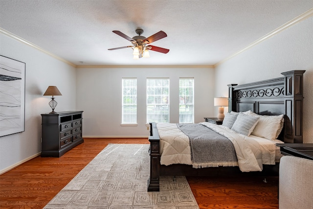 bedroom with ornamental molding, ceiling fan, a textured ceiling, and light hardwood / wood-style flooring