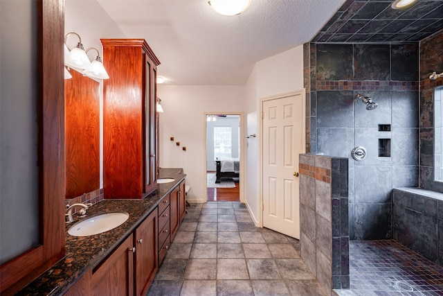 bathroom with vanity and a tile shower