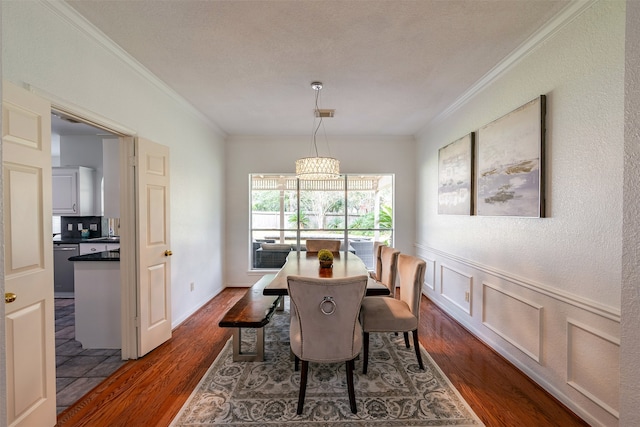 dining room with dark hardwood / wood-style flooring and ornamental molding