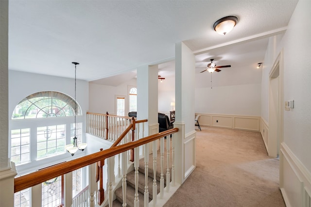 hall with light colored carpet