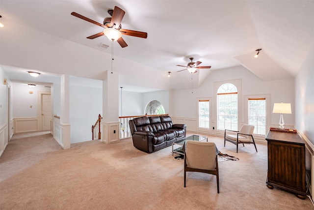 carpeted living room with ceiling fan and lofted ceiling