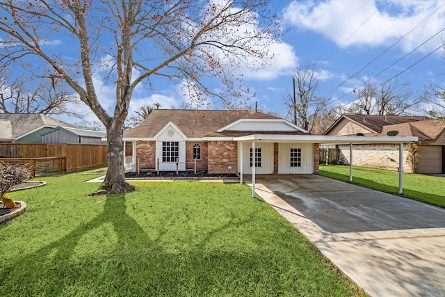 view of front of house featuring brick siding, concrete driveway, a front lawn, and fence