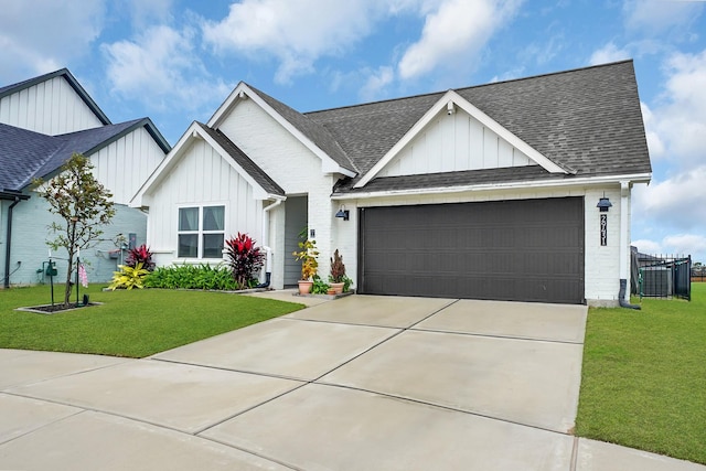 view of front of property featuring a garage and a front lawn