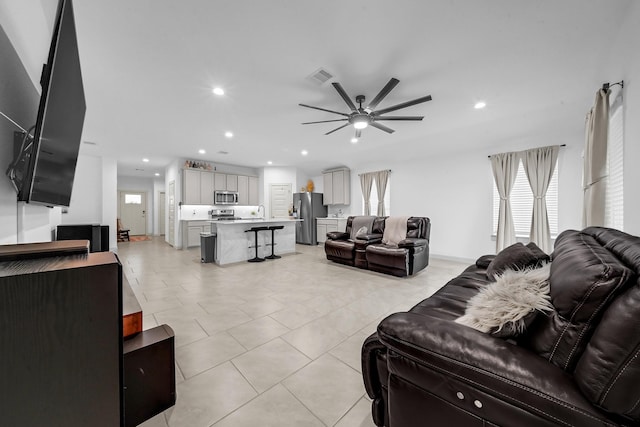 tiled living room with ceiling fan