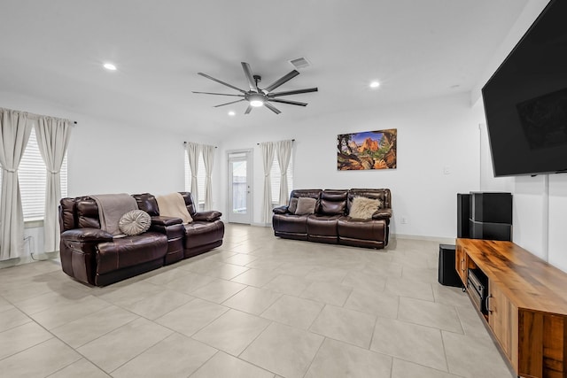 living room with vaulted ceiling, light tile patterned floors, and ceiling fan