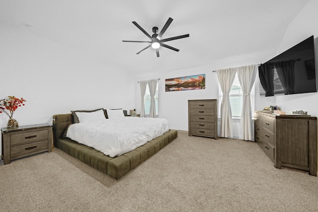 carpeted bedroom with multiple windows, lofted ceiling, and ceiling fan