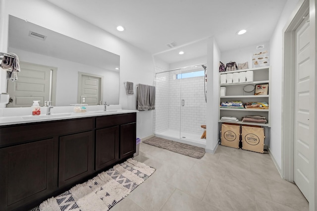 bathroom with walk in shower, tile patterned floors, and vanity