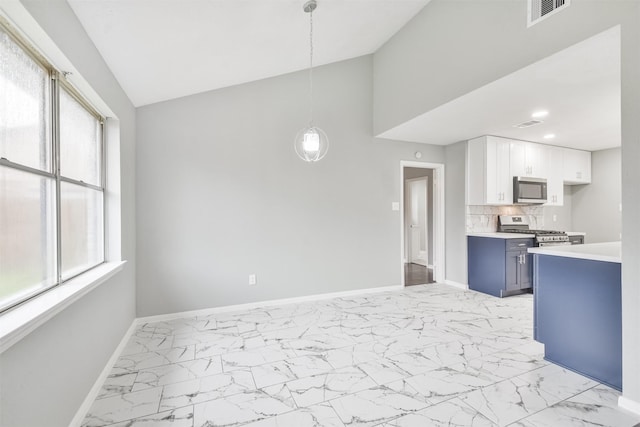 kitchen featuring blue cabinetry, lofted ceiling, white cabinetry, hanging light fixtures, and stainless steel appliances