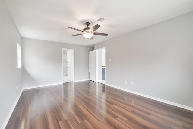 empty room with dark hardwood / wood-style floors and ceiling fan