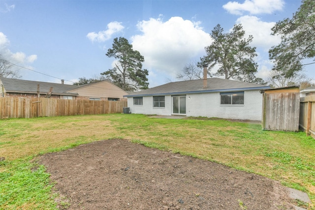 rear view of property with cooling unit and a lawn