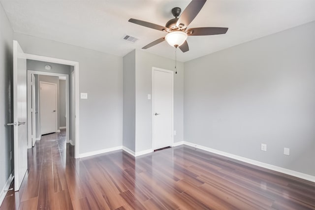 unfurnished bedroom featuring dark wood-type flooring and ceiling fan