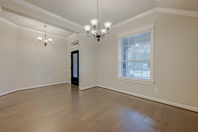 empty room featuring wood-type flooring, vaulted ceiling, a notable chandelier, and crown molding