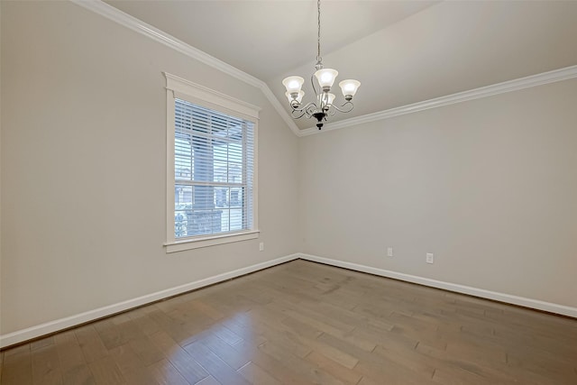 empty room with crown molding, lofted ceiling, a chandelier, and hardwood / wood-style floors