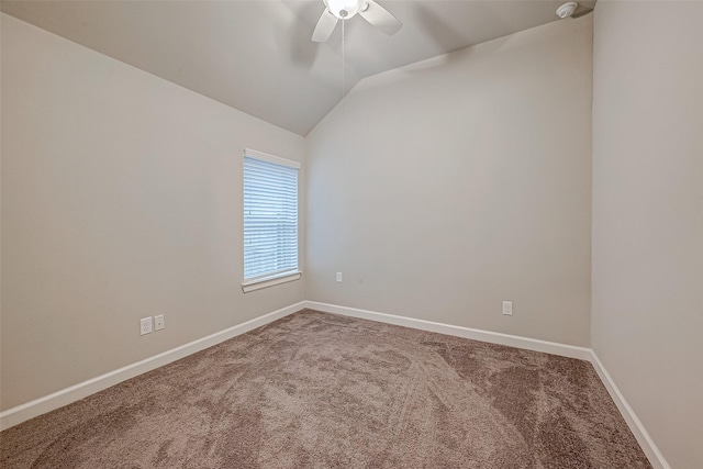 carpeted empty room with vaulted ceiling and ceiling fan